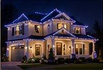Blue roofline lighting on a suburban home